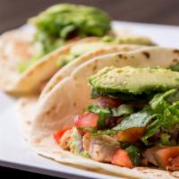 Chicken Tacos · Chicken, mild cilantro sauce, shredded lettuce, pico de gallo, avocado.