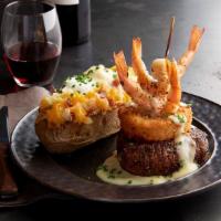 Steak & Shrimp · 7 oz Certified Angus Beef® Top Sirloin served with grilled shrimp, a Parmesan onion ring and...