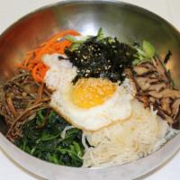 Bibimbap 비빔밥 · Rice topped with vegetables and a fried egg. Comes with side dishes and bowl of soup.