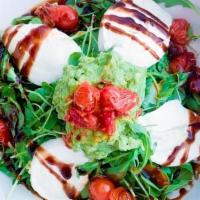 Caprese Salad · imported bufula mozzarella, heirloom tomatoes, pesto, avocado, seasonal greens, balsamic gla...