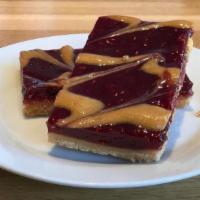 Raspberry Linzer Bar · Buttery shortbread crust topped with premium raspberry jam and almond butter