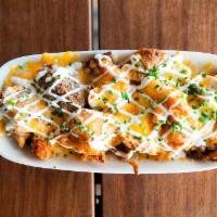 Loaded Taters · Crispy Idaho russets, cheese sauce, aged cheddar, smoked bacon, sour cream & chives