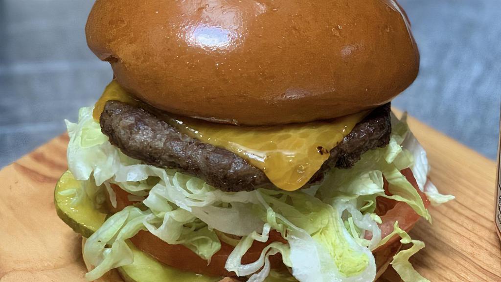 Cow Burger · Wagyu Beef, Cheddar, Lettuce, Tomato, Pickle, Onion, Smokey Sauce, Brioche Bun