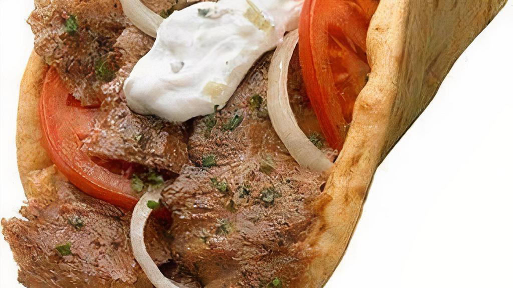 Mediterranean Gyro · Our Hand-made Gyro is Prepared with Thinly Sliced Marinated Authentic  Lamb and Beef Meat.

Served with Diced Vine-Ripened Roma Tomatoes & Onions, Topped with Our Famous Homemade Made Tzatziki (Yogurt) Sauce on Pita Bread.