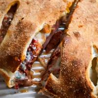 Meat Calzone · Included toppings: pizza sauce, ricotta cheese, mozzarella, ham, Canadian bacon and pepperoni.