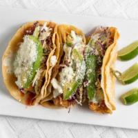 Baja Fish Taco (3) · Beer battered cod, cabbage slaw, avocado, cojita, crema, house salsa roja and corn tortilla.
