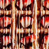 Kinder Nutella Waffle · True brown Belgian waffle, covered with Nutella and Kinder sauce, toped with strawberry, ban...