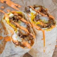 Impossible  Haus Burrito · 3 fried eggs, Impossible Sausage patty, white american cheese, crispy tater tots, caramelize...