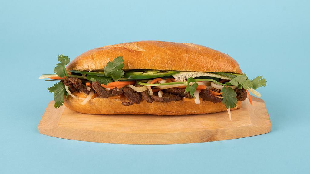 Pork Banh Mi · Grilled sliced pork with cucumber, jalapeno, cilantro, pickled carrots and sriracha mayo on a french roll.