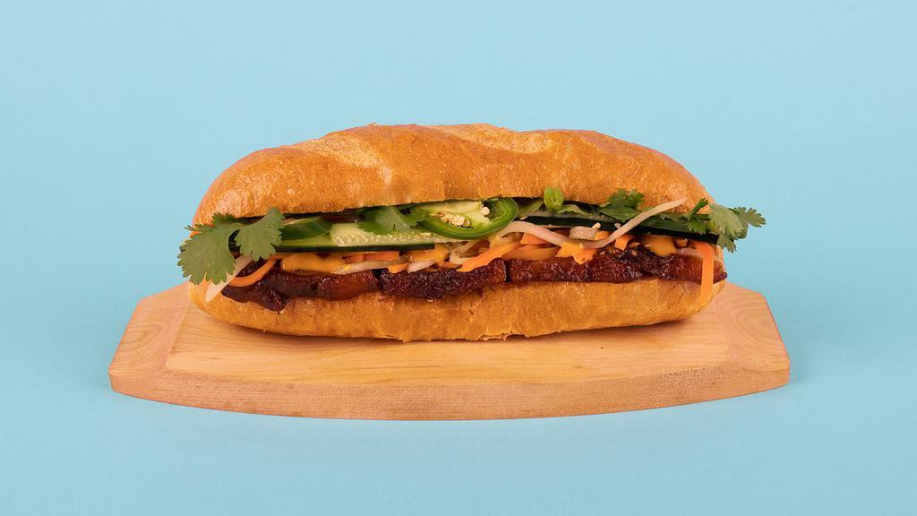Pork Belly Banh Mi · Pork belly with cucumber, jalapeno, cilantro, pickled carrots and sriracha mayo on a french roll.