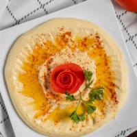 Hummus · A Mixture of garbanzo beans with a touch of garlic, lemon juice,
and tahini sauce, topped wi...