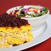 Tahchin · Crusted rice mixed with yogurt, eggs and saffron with layer of boiled chicken at the middle ...