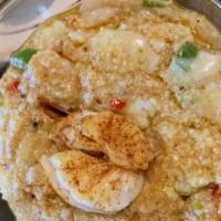 Shrimp Grits · Slow steamed Grits, Shrimp sautéed with, green onions, red and green bell peppers, cajun spi...