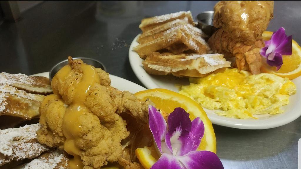 Cajun Fried Lobster Tail & Waffles · Tender cajun seasoned, deep fried Lobster Tail served with Waffles, 2 eggs, choice of Buttered Grits or Hash Browns