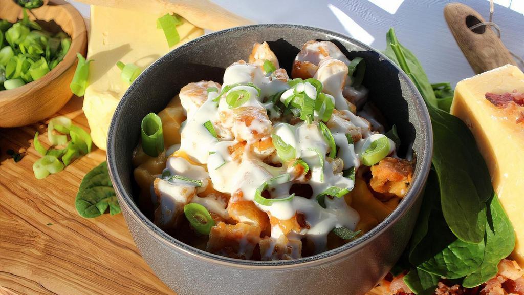 Ranch Style Mac N Cheese · Our Homestyle Mac N Cheese Topped with Crispy All White Meat Chicken Tenders, Fresh Green Onion and Topped off with our Homestyle Ranch Dressing