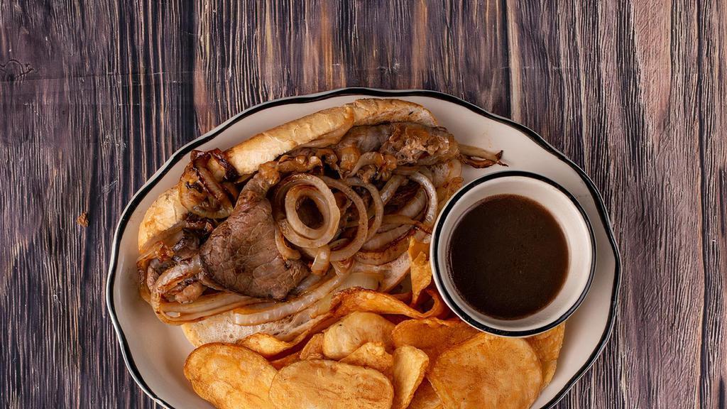 French Dip Sandwich · A generous portion of thinly sliced roast beef brisket piled high on a toasted French roll with caramelized onions. Served with au jus for dipping.