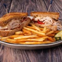 Turkey Delight Sandwich · Sliced turkey, bacon and tomato with melted Swiss cheese. Served on grilled sourdough bread.
