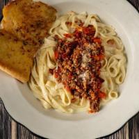 Fettuccine Alfredo With Bolognese Pasta · Fettuccine noodles with garlic cream sauce. Topped with bolognese and parmesan cheese.