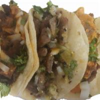Beef Taco · Seasoned grilled beef served on corn tortilla with onion, cilantro, lime and spicy salsa on ...