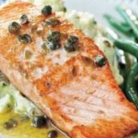 Salmon In Capers Sauce · Salmon steak over garlic mashed potatoes topped with tomatoes, caper sauce and a side of sau...