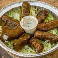 Dolmeh · Five cooked grape leaves filled with rice, split peas, and fresh herbs served with pita.