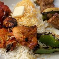 Joojeh Kebab · a skewer of Persian spiced marinated chicken kebab grilled over an open flame.