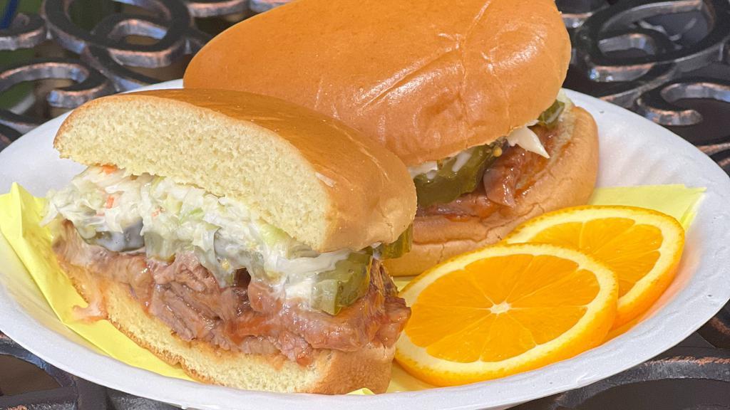 Smoked Brisket Sandwich · Slow Smoked Brisket, Cole Slaw, Onions, Pickles on a toasted Brioche bun.