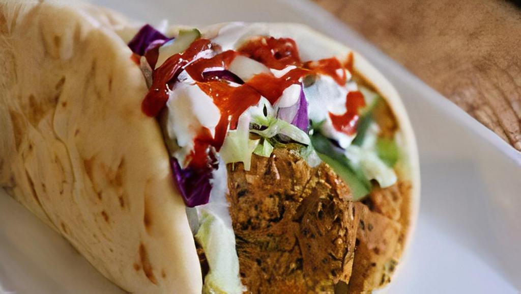 Falafel Wrap · Patty made from ground chickpeas, wrapped in a warm pita topped with lettuce, onion, cabbage, cucumber and your choice of house white sauce, hot sauce, or BBQ sauce.