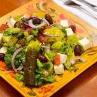 Greek Salad · Tomato, lettuce, cucumber, red onion, olives, grape leaves, and feta cheese.