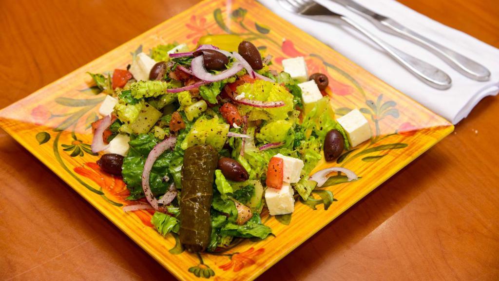 Greek Salad · Tomato, lettuce, cucumber, red onion, olives, grape leaves, and feta cheese.