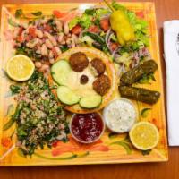 Veggie Plate Lunch · Three falafel, salad, hummus, mutabal, taboule, and pita bread.