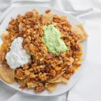 Nachos · Choice of meat on top of corn tortilla chips w/ beans, melted cheese, sour cream and guacamole