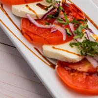 Mozzarella Caprese · Tomato, Fresh Mozzarella, Red Onion, Basil, Balsamic Reduction Served with Sliced Baguette.
