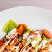 Buffalo Chicken Salad · Crispy White Meat Chicken Tenders Glazed in Our Buffalo Sauce, Spread Over Romaine Lettuce W...