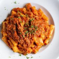 Rigatoni Bolognese · Rigatoni tossed in our homemade bolognese sauce topped with a dollop of fresh ricotta.