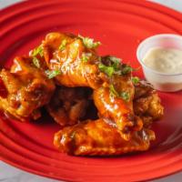 Classic Bbq · 8 traditional wings* tossed in BBQ (mild heat), served with carrots & celery and a dipping s...