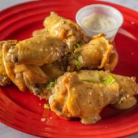 Garlic Parmesan · 8 traditional wings* tossed in garlic parmesan (mild heat), served with carrots & celery and...
