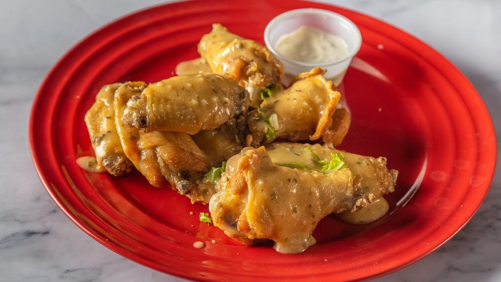 Garlic Parmesan · 8 traditional wings* tossed in garlic parmesan (mild heat), served with carrots & celery and a dipping sauce of your choice.