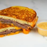 Roast Beef & Cheese Monte Cristo · Roast beef, Cheddar, Swiss, and Parmesan cheeses melted between egg dipped, griddled sourdou...