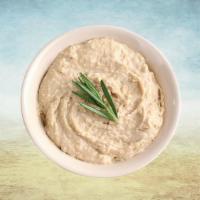 Hummus Huba Huba · Chickpeas boiled till soft, mashed, blended and mixed with garlic, tahini sauce, olive oil a...