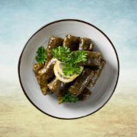 Dolma Destiny  · Grape leaves dumplings filled with tender ground spiced beef, rice, tomatoes, and fresh herb...