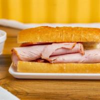 Turkey Dip · Thin sliced smoked turkey, served on a baguette roll, with a side of au jus sauce. Add chees...