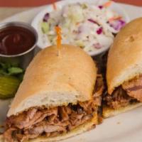 Cowboy Tri-Tip Sandwich Combo · Thin sliced tri-tip, onion rings, diced green chillies, BBQ sauce, served on a baguette roll.