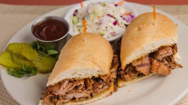 Cowboy Tri-Tip Sandwich Combo · Thin sliced tri-tip, onion rings, diced green chillies, BBQ sauce, served on a baguette roll.