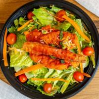 Spicy Buffalo Chicken Tender Salad · Crispy chicken tenders tossed in a spicy buffalo sauce, mixed cheese, tomato, served over ic...