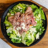 Tri-Tip Caesar Salad · Thin sliced tri-tip, Parmesan cheese, croutons, served over romaine lettuce, served with Ces...