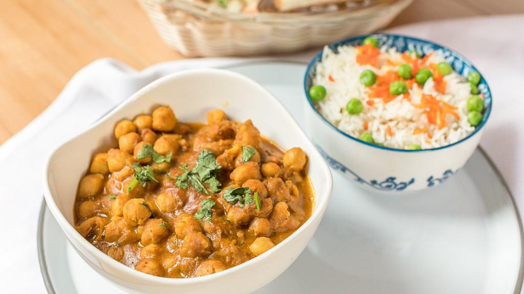 Chana Masala · Chickpeas cooked with onion and tomato fired masala.