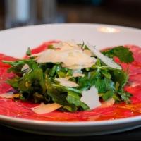 Carpaccio Di Manzo · Thinly sliced filet mignon topped with fresh arugula, shaved Reggiano and extra virgin olive...