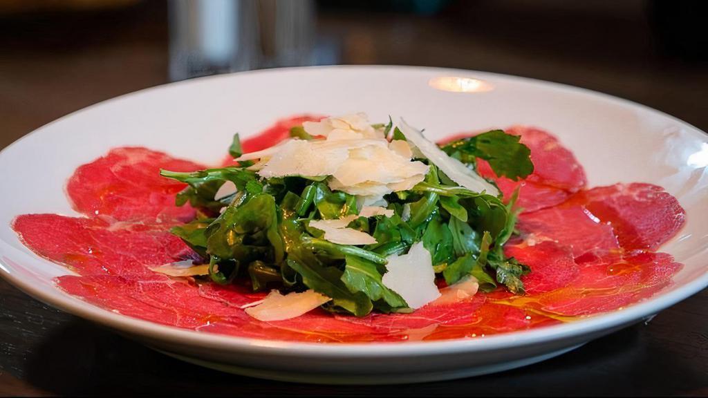 Carpaccio Di Manzo · Thinly sliced filet mignon topped with fresh arugula, shaved Reggiano and extra virgin olive oil.