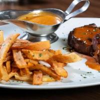 Steak Au Poivre · Filet mignon in peppercorn sauce, with French fries.
